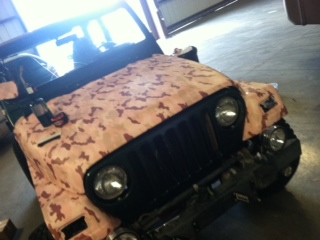 Jeep with camo on the hood